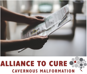 Person holding newsletter with Alliance to Cure logo at bottom