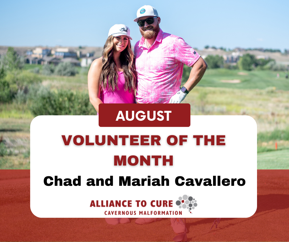 August Volunteer of the Month, Chad and Mariah Cavallero. Photo of a man and woman both wearing pink shirts and baseball caps. Chad has a beard and is wearing sunglasses and Mariah has long brown hair.