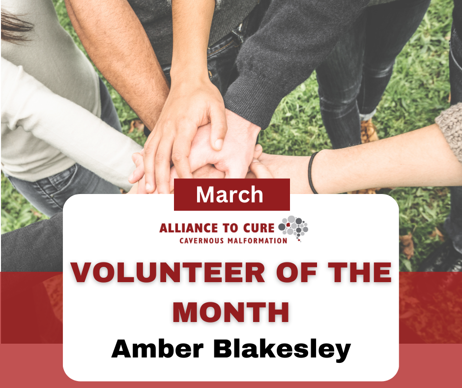 Six people with hands reached into the center a circle in solidarity. The text says Volunteer of the Month Amber Blakesley.