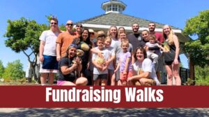 A group of about 20 people smiling during our Strides to Cure CCM 2023 walk, run, roll. The picture is a link to our Fundraising Walks page.