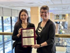 Dr. Sandi Lam and Dr. Connie Lee posing with the Alliance to Cure's CCM Center plaque during the presentation
