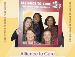 Photo of five Alliance to Cure staff members smiling and posing in a photobooth frame with the Alliance to Cure logo on it.