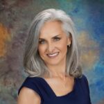 Christina Campos headshot. An Hispanic woman with shoulder-length gray hear wearing a sleeveless black top smiling.