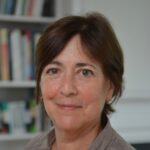 Dorothy Robinson headshot - white woman with short brown hair wearing brown collared shirt, smiling