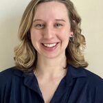 Headshot of a smiling young white woman with shoulder-length blonde hair.