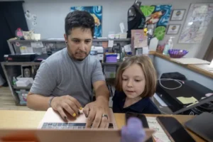 a child and a man working together.